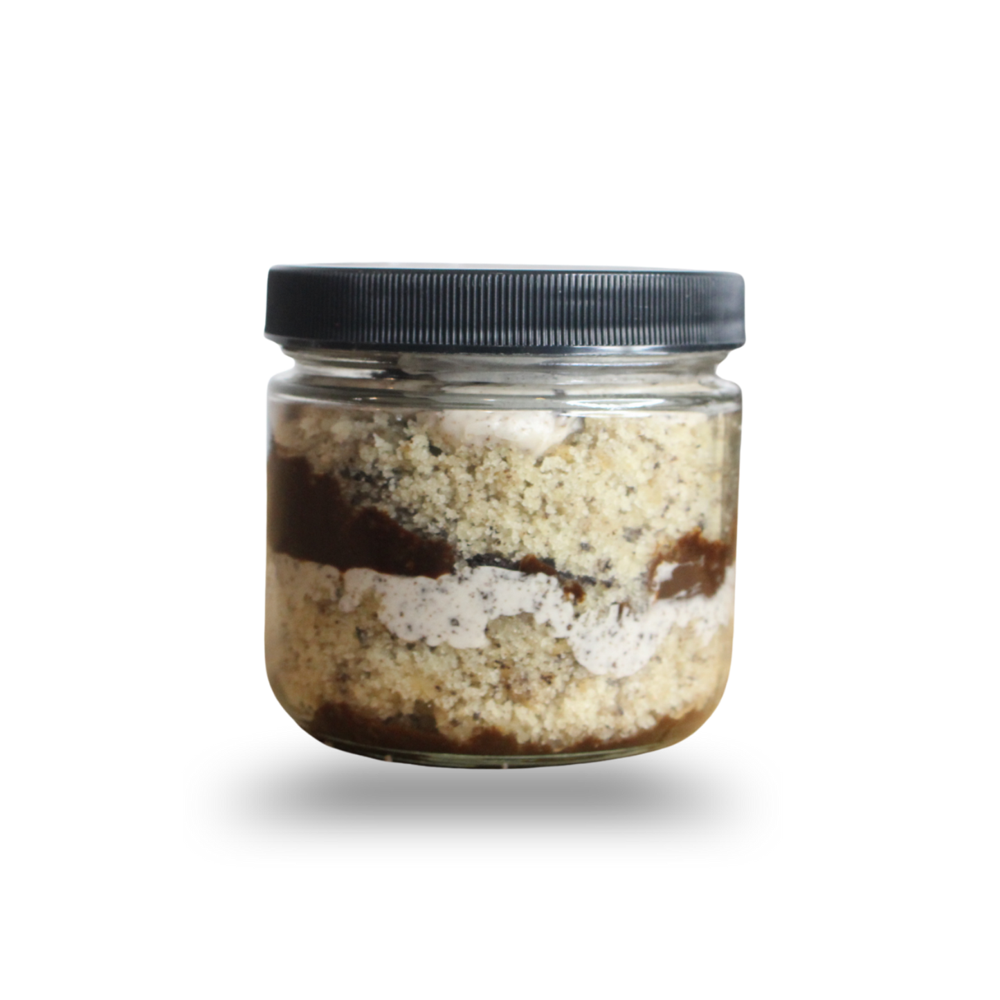 Jar of layered dessert on a white background