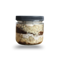 Jar of layered dessert on a white background