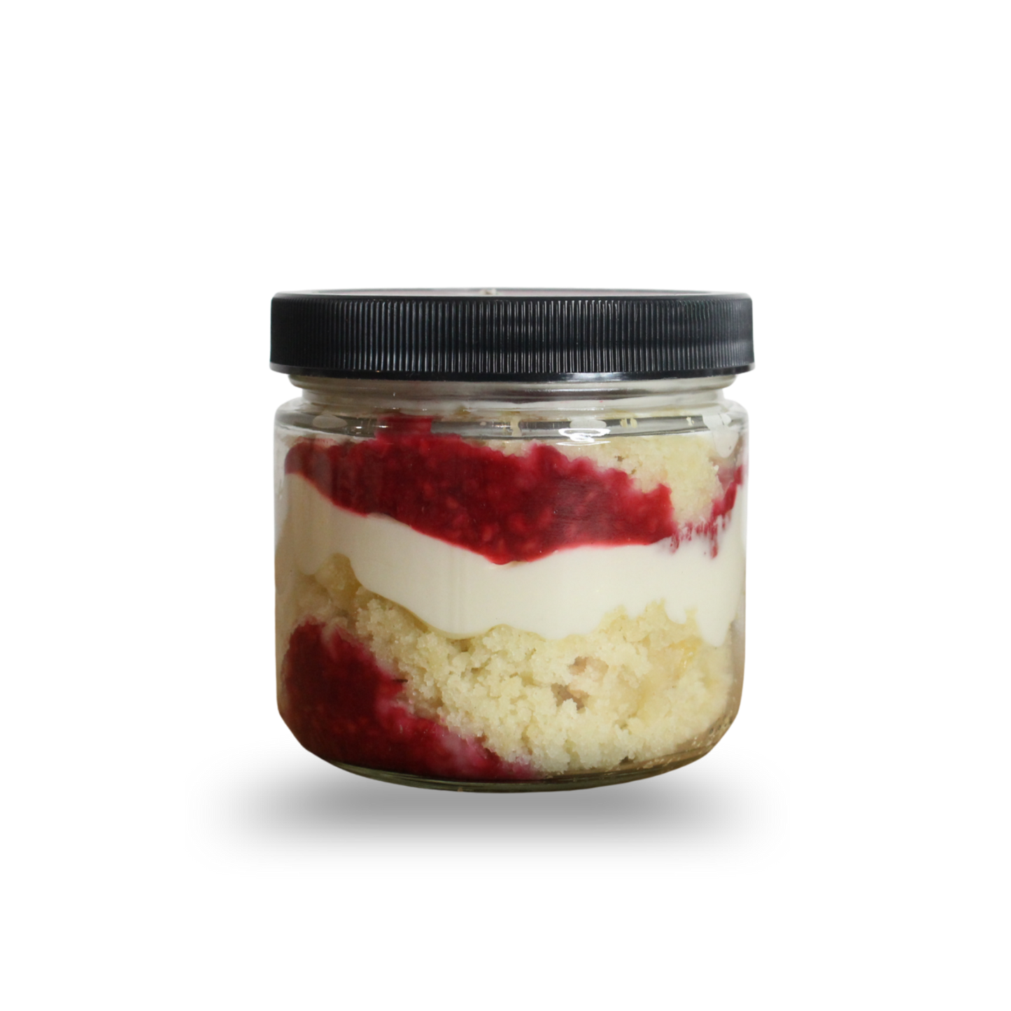 Layered dessert in a glass jar with a black lid on a white background